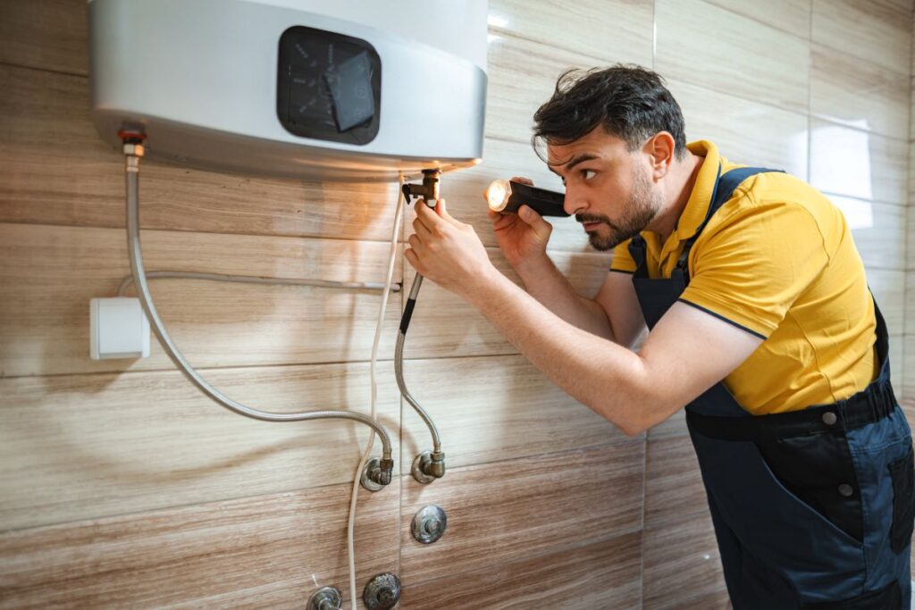 professional plumber inspecting water heater
