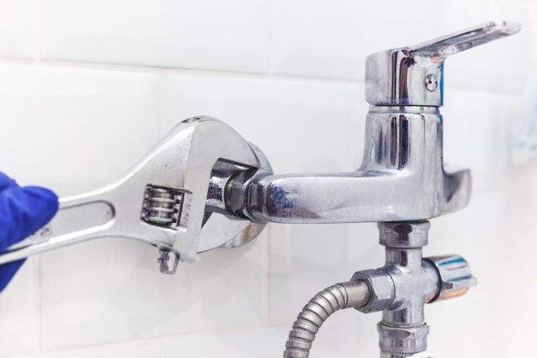 Adjustable spanner and pipe fitting on white background-Emergency Plumbers Beldon