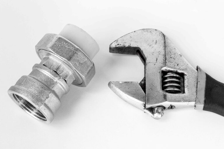 Adjustable spanner and pipe fitting on white background-Gas Leak Repair Caversham