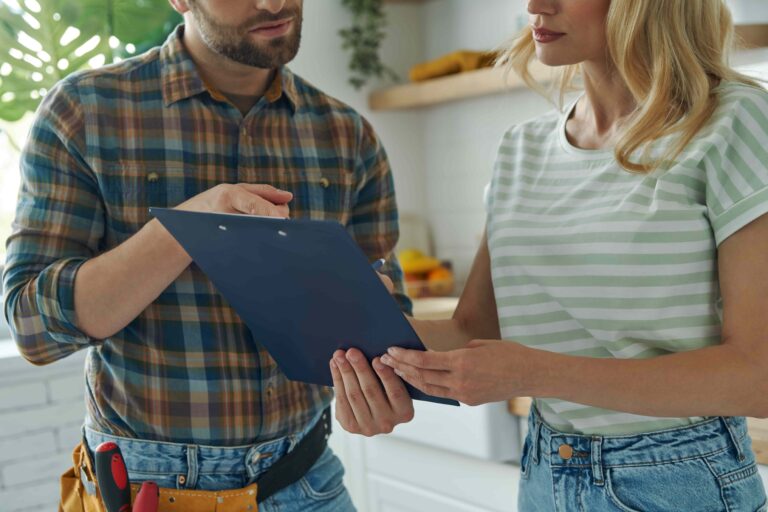 Plumber showing a clipboard to a client in the kitchen-Gas Appliance Installation Floreat