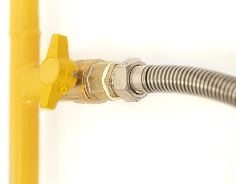 Yellow gas pipe with valve and metal hose