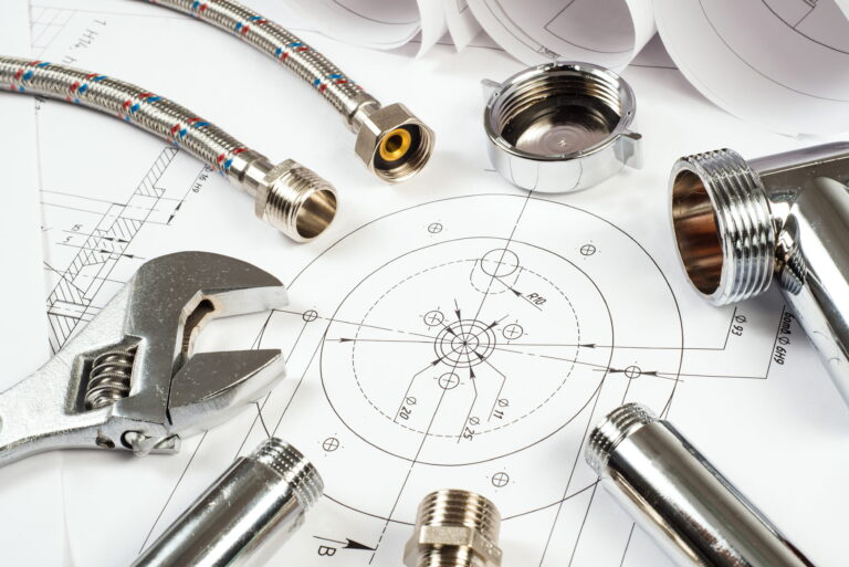 Plumbing tools and parts on construction blueprints-Backflow Prevention Burns Beach