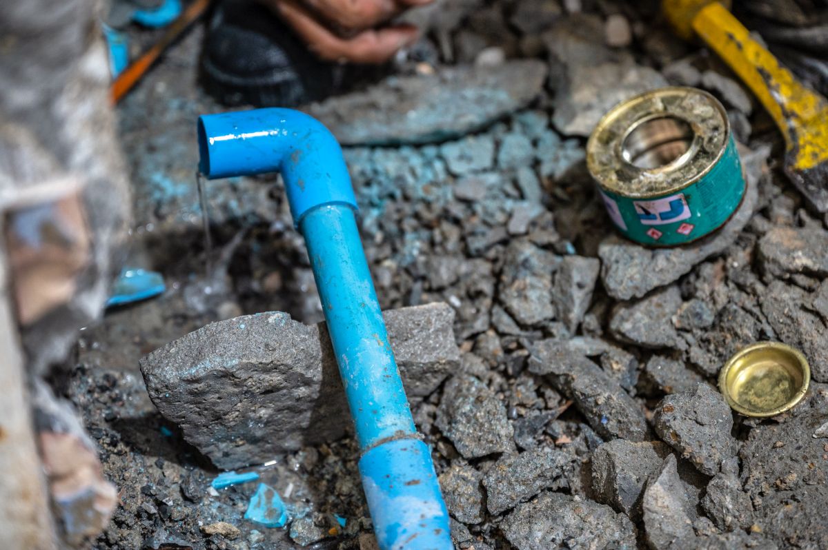 Plumber repairing a leaking pipe