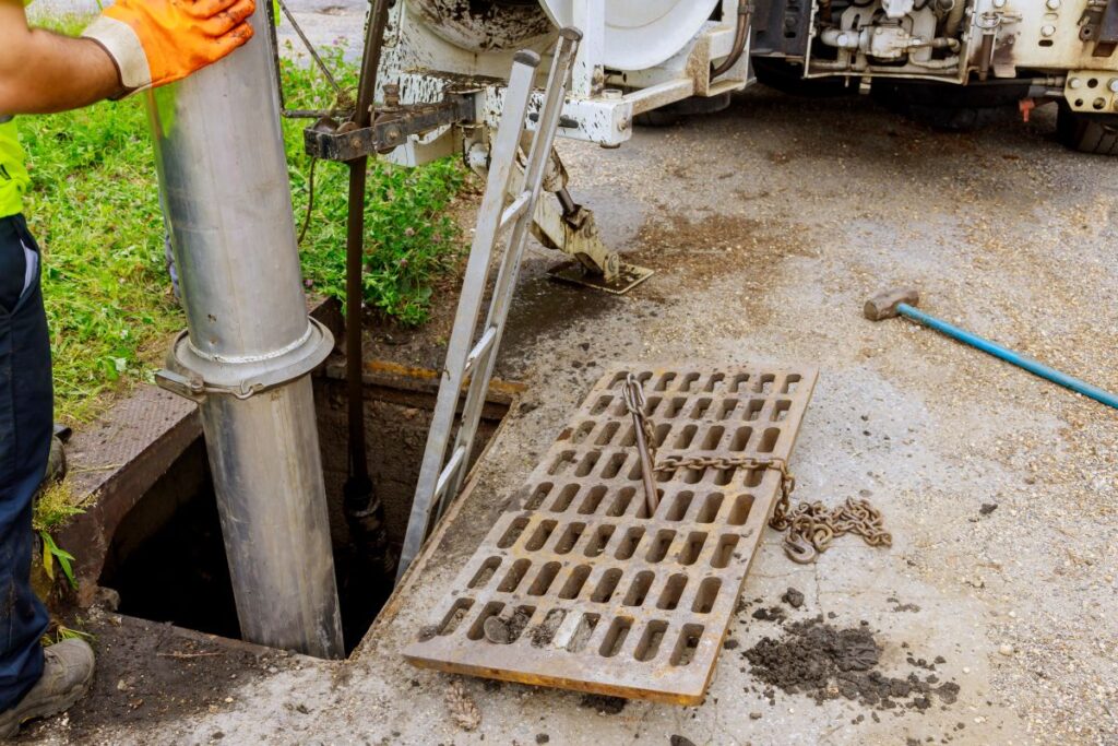 Plumber repairing underground blocked drainage system